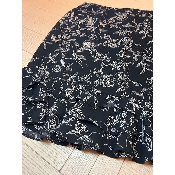 Floral print zip closure w/ elastic waist knee length skirt with ruffle trim. 12 - Picture 5 of 9